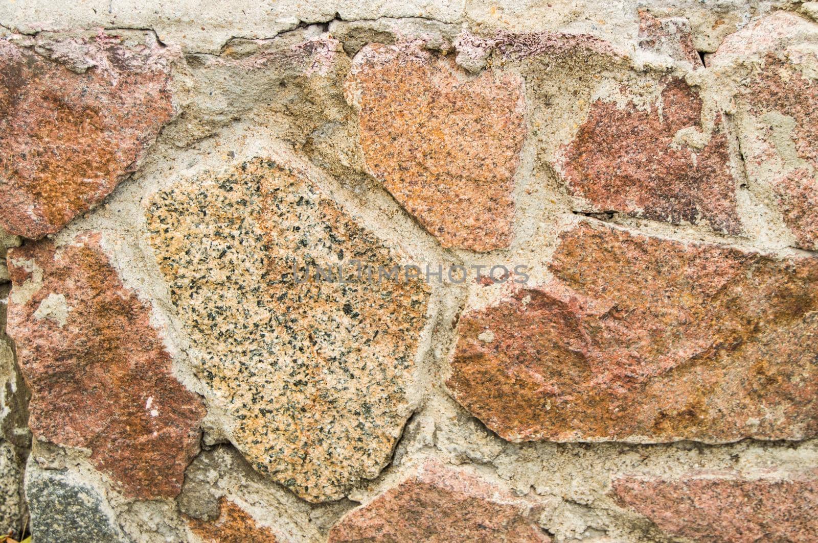 background stone walls of pink granite, texture