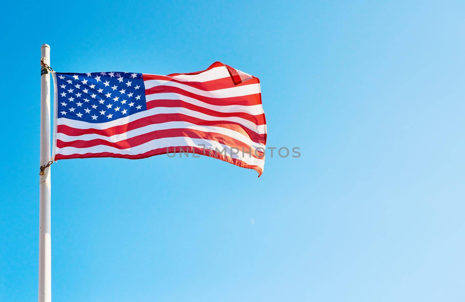 Low angle shot of the American flag standing on its own outside during the day.