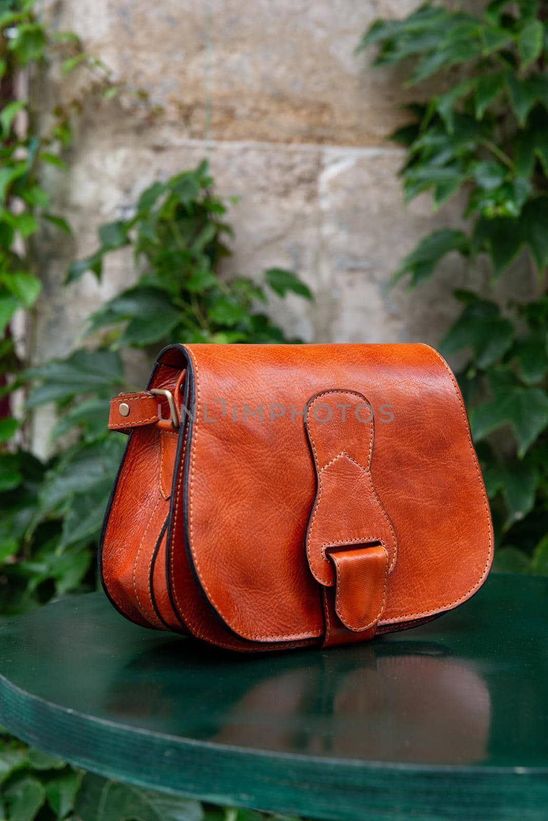 small orange women's leather bag . street photo