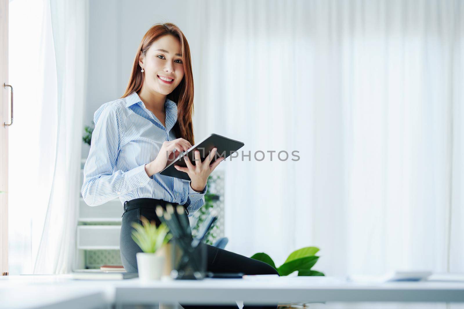 Entrepreneurs, Business Owners, Accountants, Portrait of a Small Business Startup Asians showing happy smiling faces with tablets at work