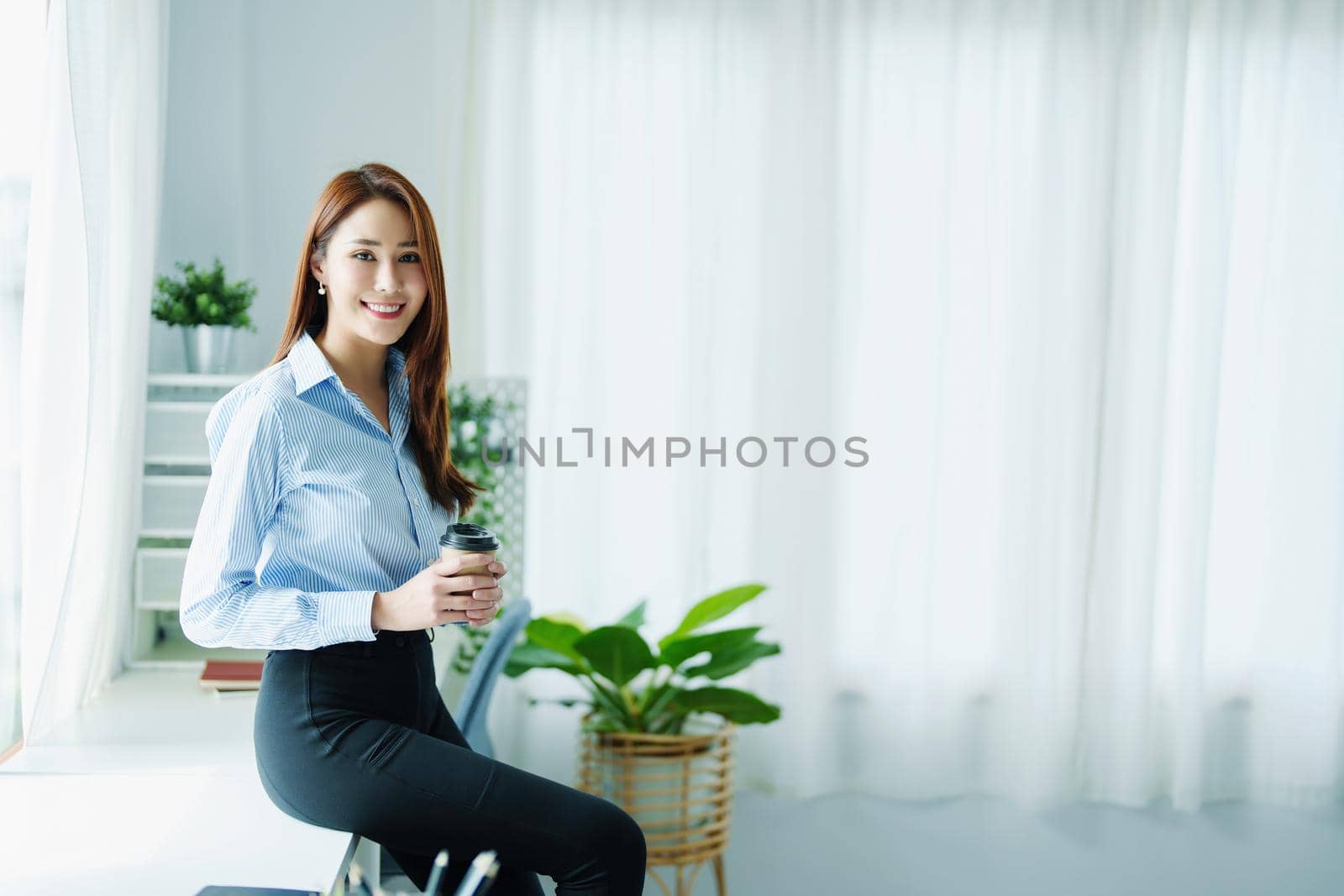 Entrepreneurs, Business Owners, Accountants, Portrait of a Small Business Startup Asians hold happy smiling faces while drinking coffee while taking a break from work. by Manastrong