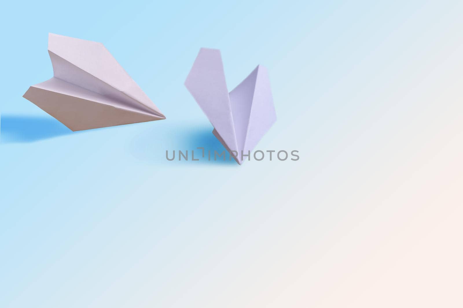 two paper planes on a white background.