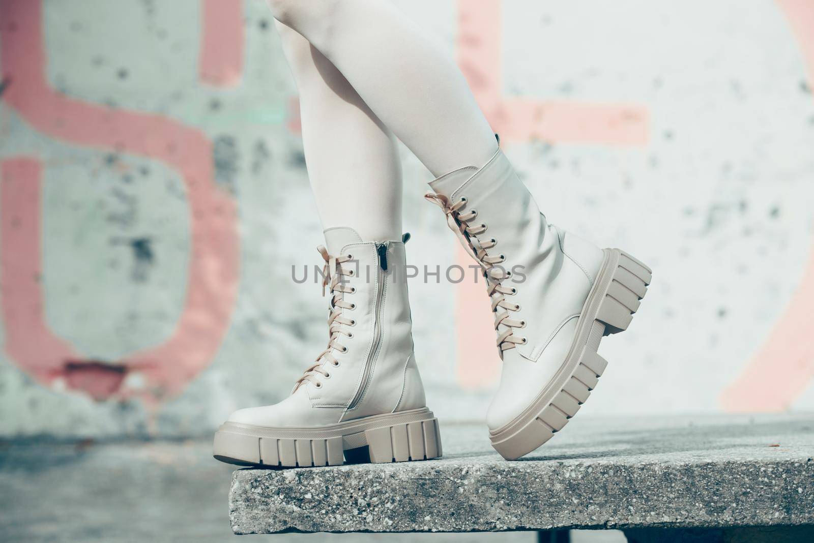 Female legs wearing white fashion boots with laces by Ashtray25