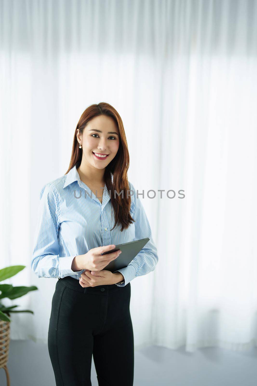 Entrepreneur, Business Owner, Accountant, Portrait of Starting small businesses Asians holding a smiling tablet in the office. by Manastrong