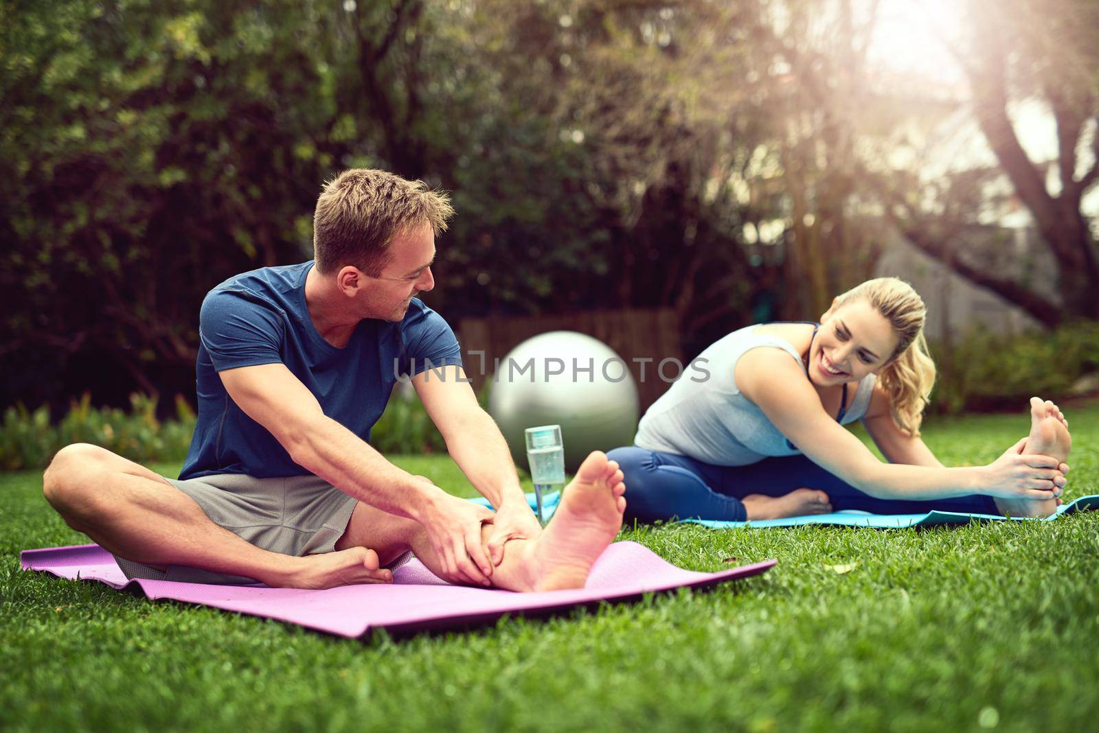 Shot of a young couple exercising together outdoors.