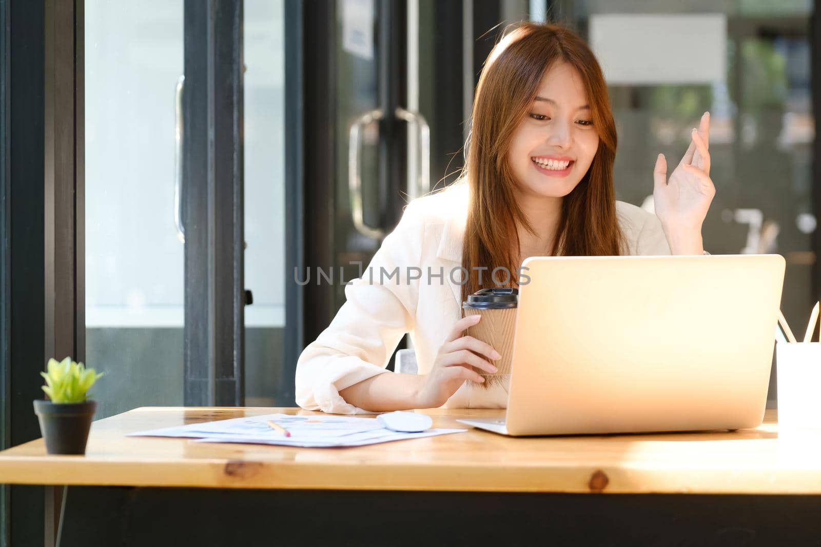 Businesswoman making video call to business partner, webcam chat. Cheerful young businesswoman video chats with colleague..