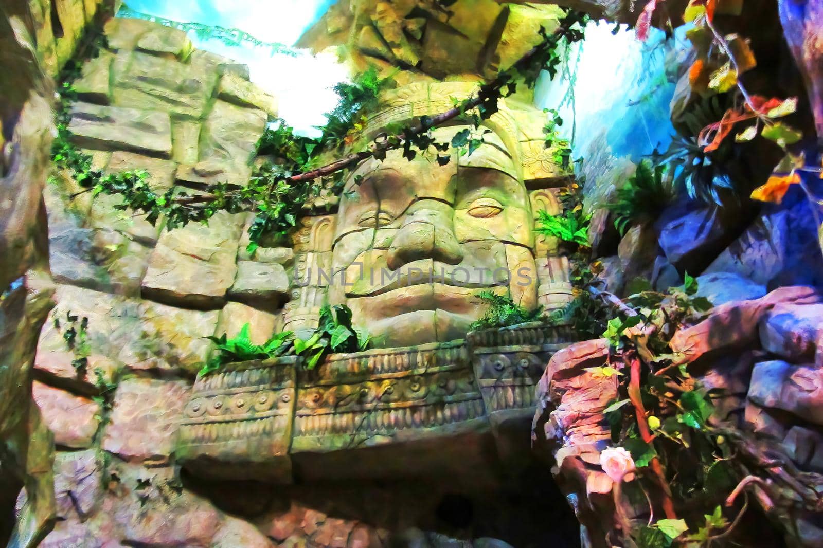 Olmec sculpture carved from stone. Mayan symbol - Big stone head statue in a jungle on image