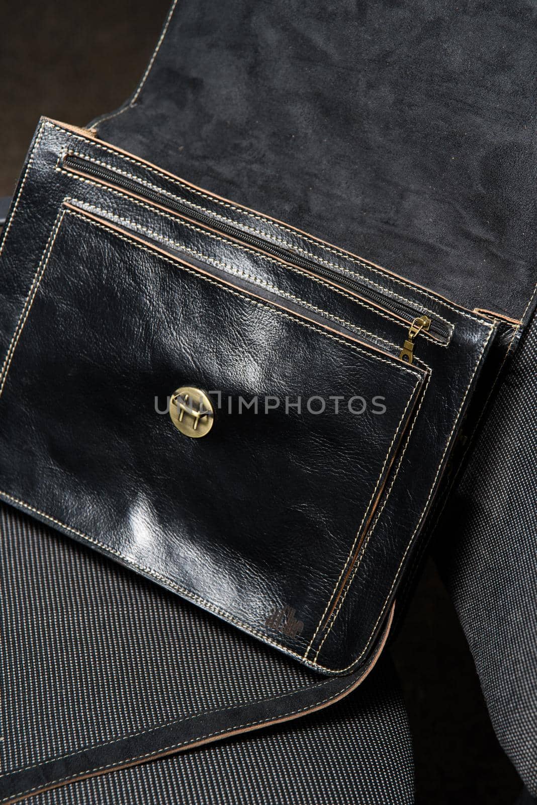 Open black leather briefcase with antique and retro look for man on a office chair. photo taken in a conference hall by Ashtray25