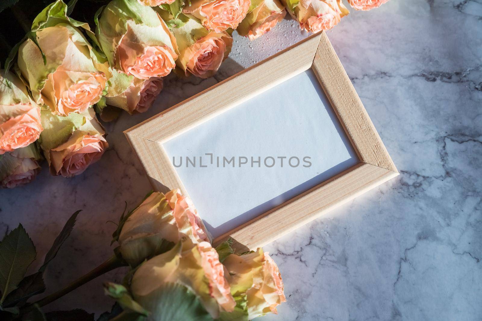 gold picture frame with decorations. Mock up for your photo or text Place your work, print art, roses in vase