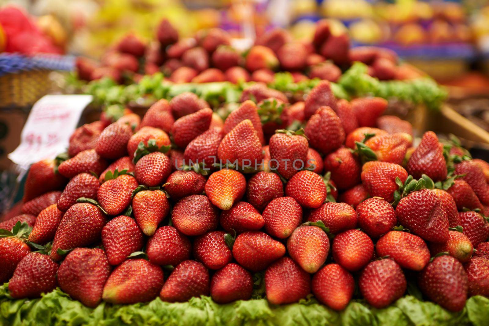 Juicy strawberries. A display of delicious red strawberries at a food market. by YuriArcurs