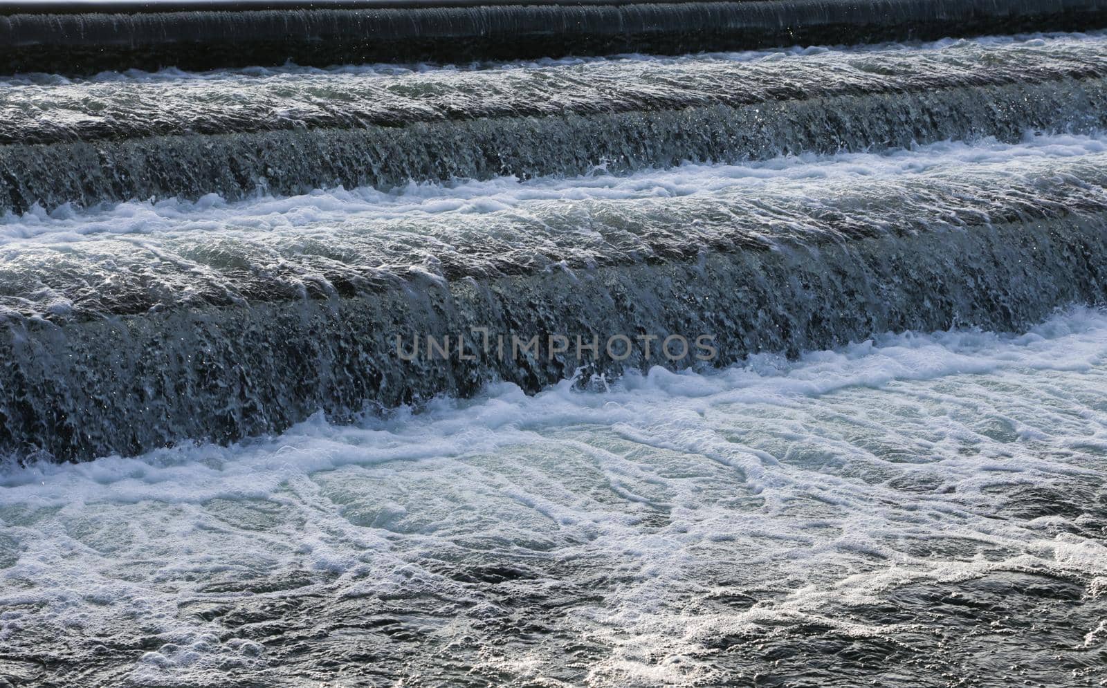 A close-up of a waterfall descending from a lake.