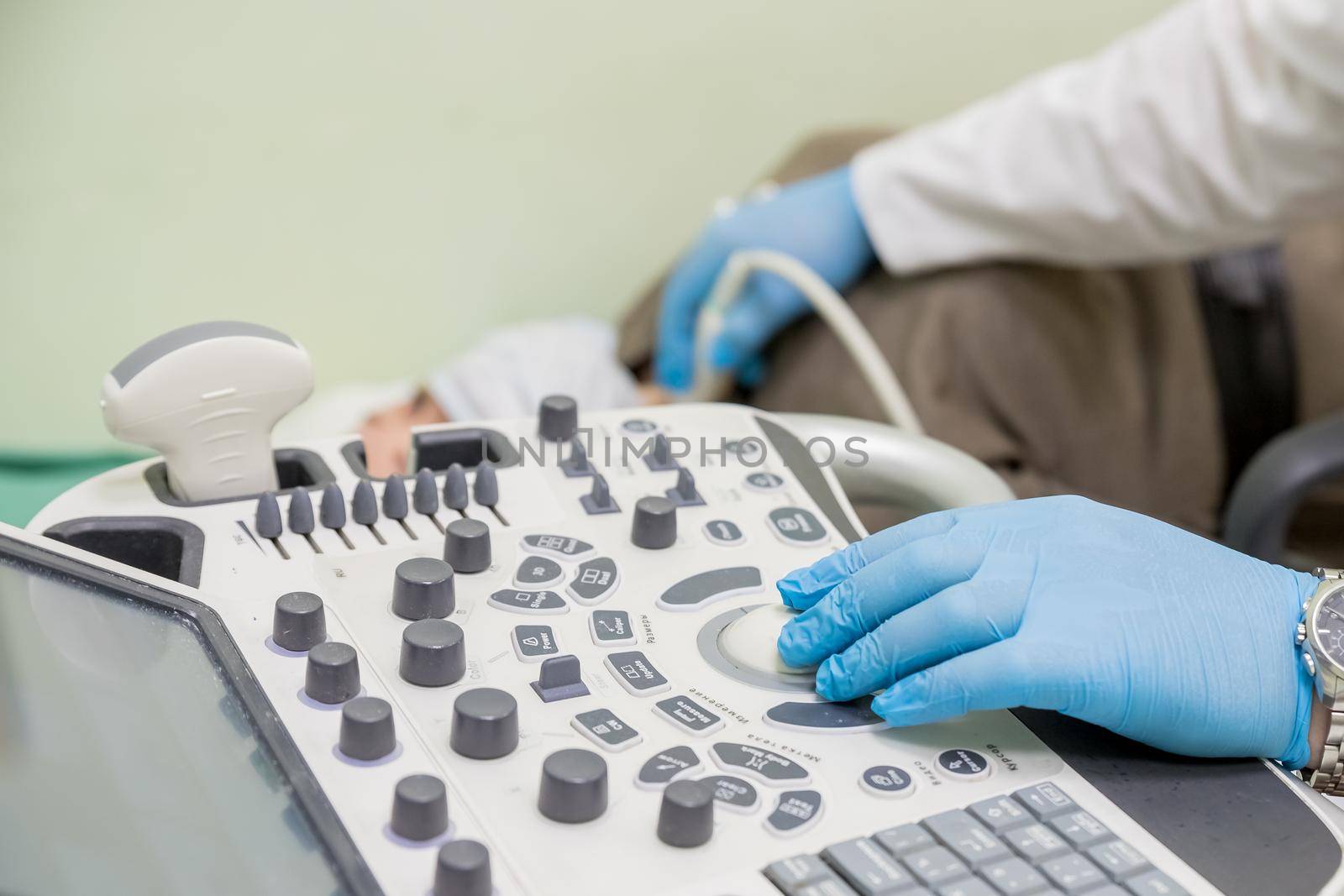 gynecologist doctor prepares an ultrasound machine for the diagnosis of the patient.