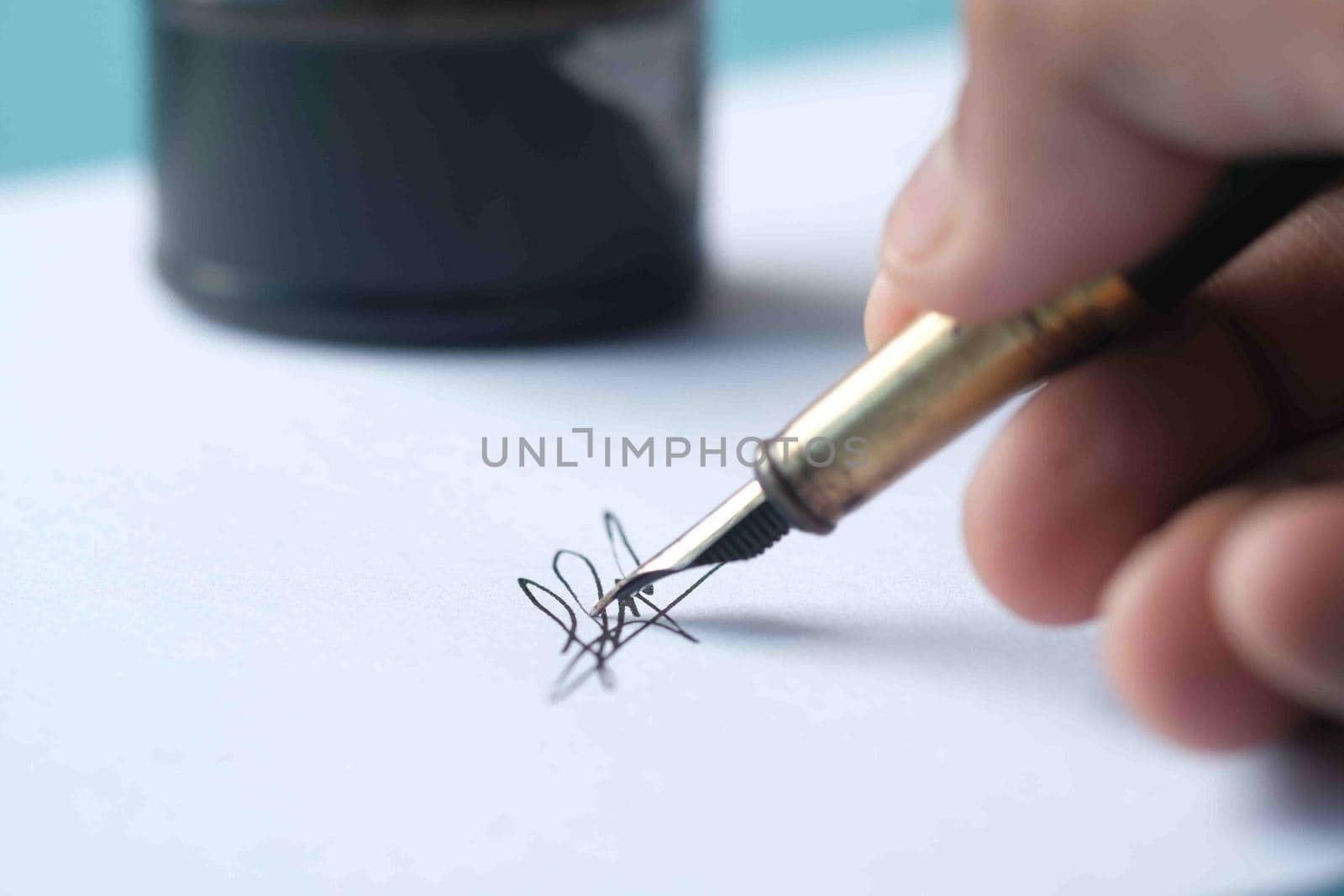 Close up of man hand writing a letter with fountain pen.