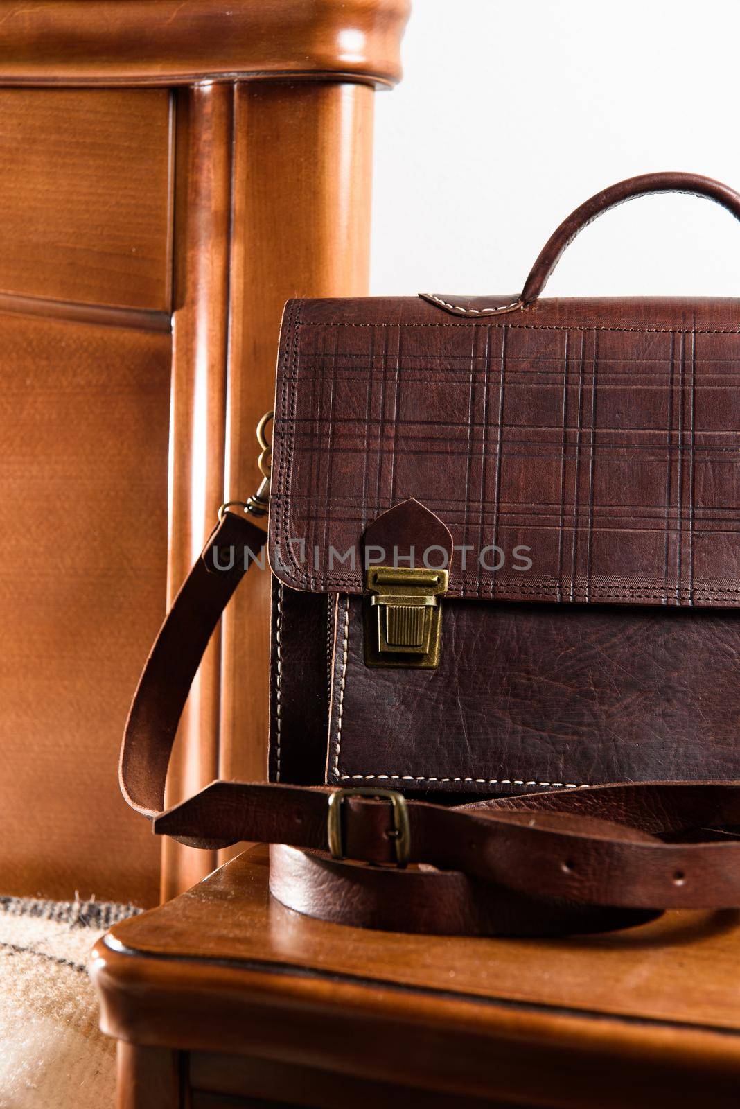 Brown leather briefcase in a cell with two locks. hotel room photo.