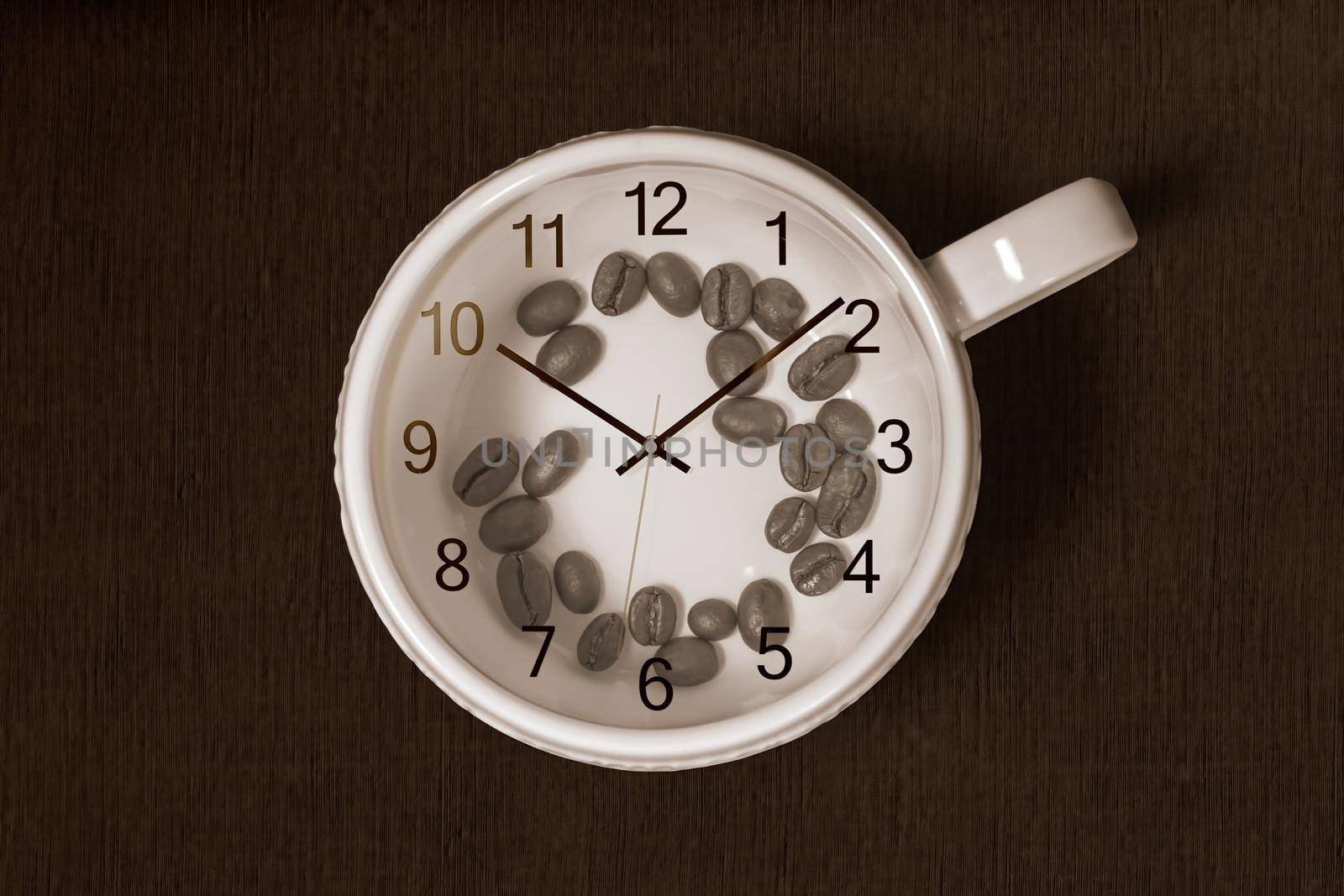 Coffee cup with coffee beans inside and a clock on top of the cup on dark background. Coffee time concept