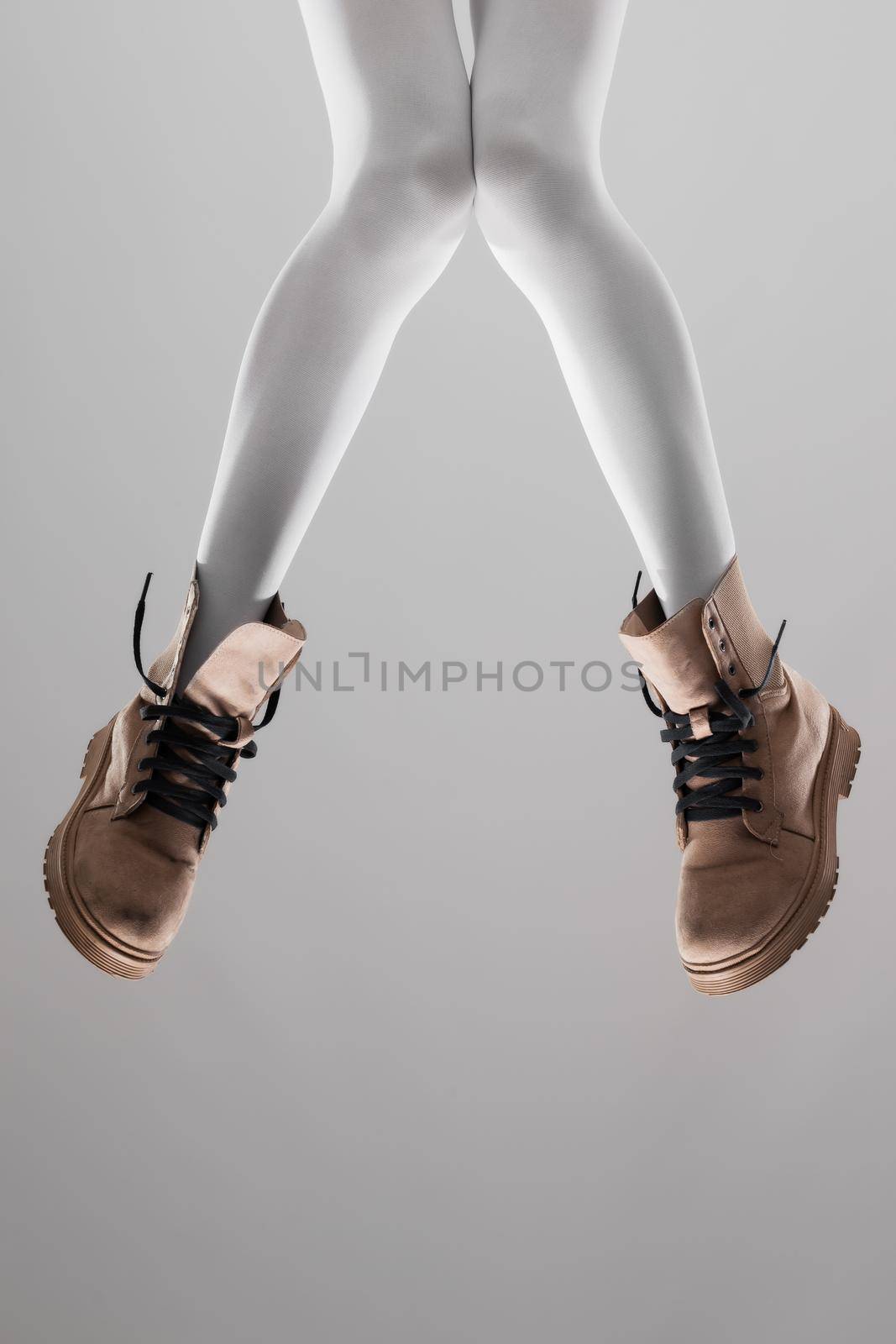 Sexy female legs with white leggings and waterproof boots.. by kokimk