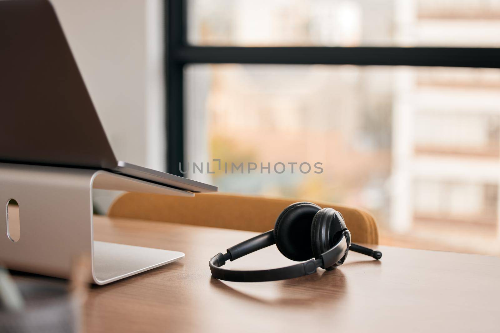 Still life shot of a wireless headset on a desk in a call center.