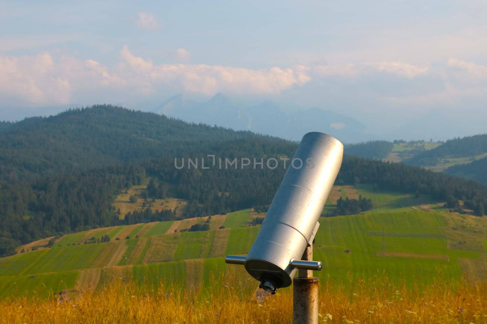 Large binoculars for viewing into the distance against the backdrop of the mountains. by kip02kas