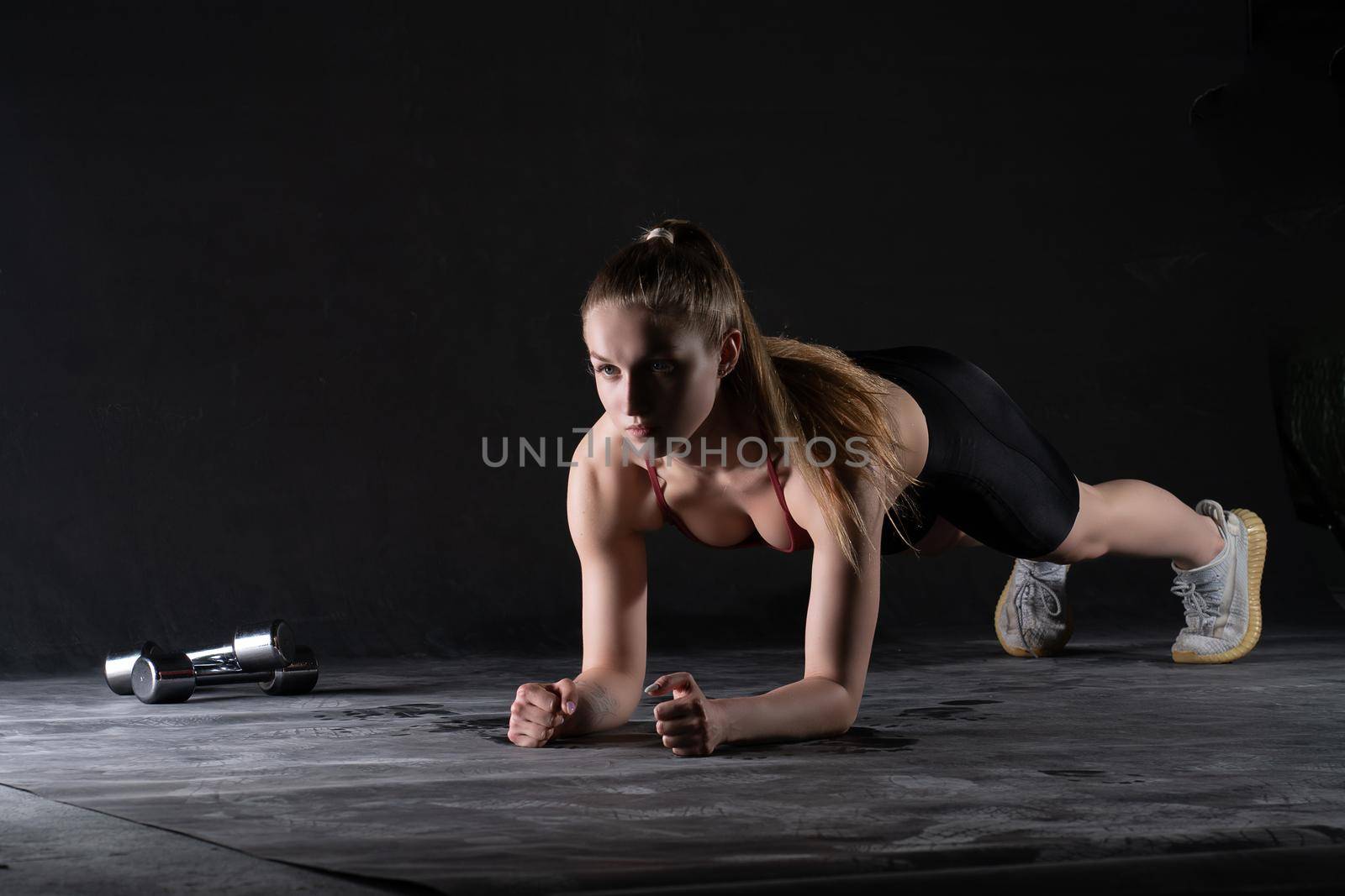 Girl dumbbells stands a the on plank in with the floor push-ups looks like a kira knightley girl fitness workout, In the afternoon caucasian health in woman for healthy trainer, sportswear