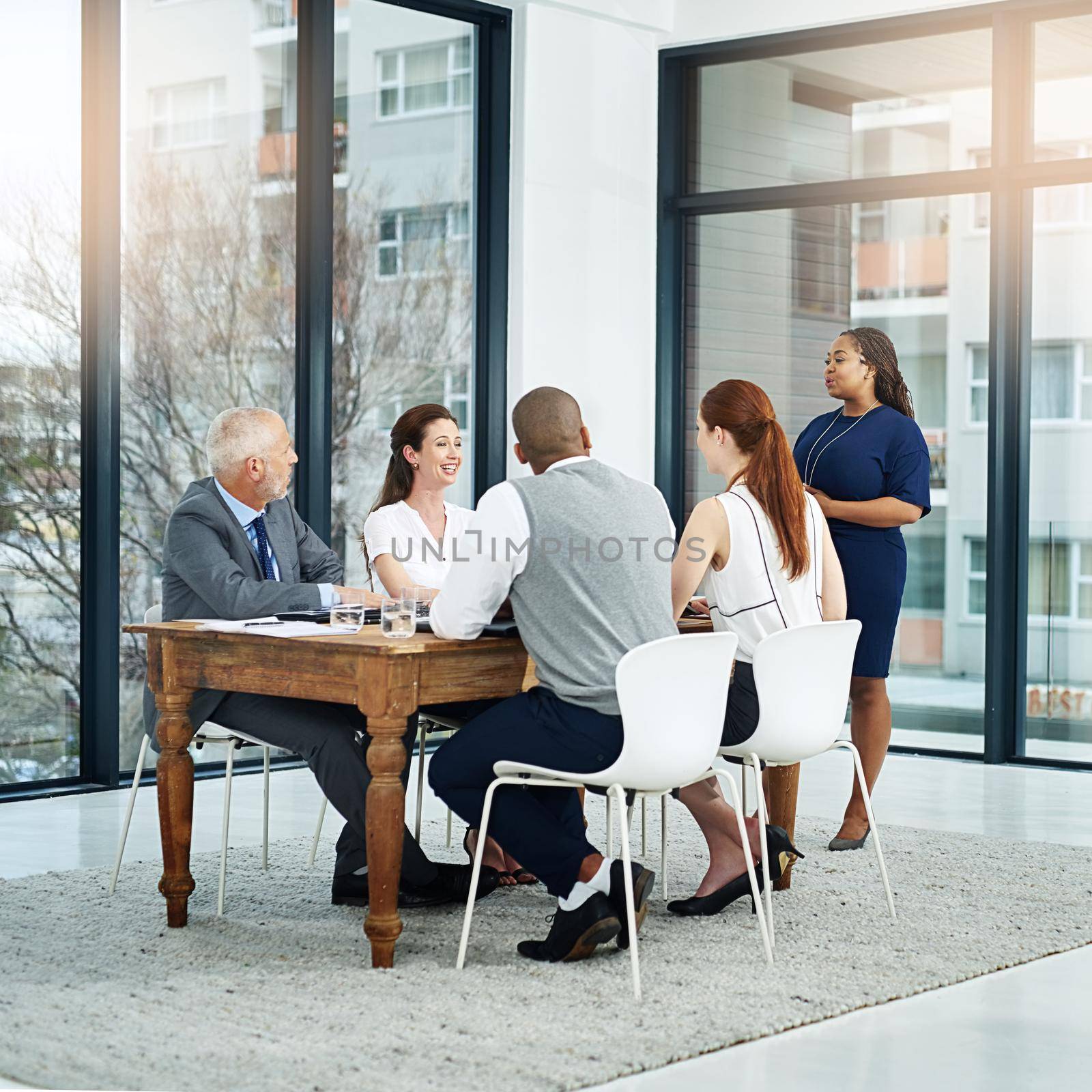 Full length shot of a young businesswoman giving a presentation in the boardroom.