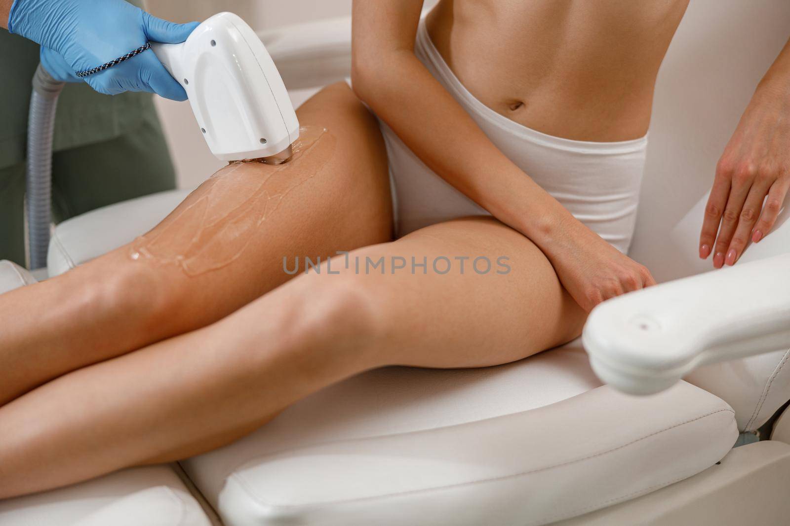 Closeup of legs skin epilation with ipl machine in beauty salon by Yaroslav_astakhov