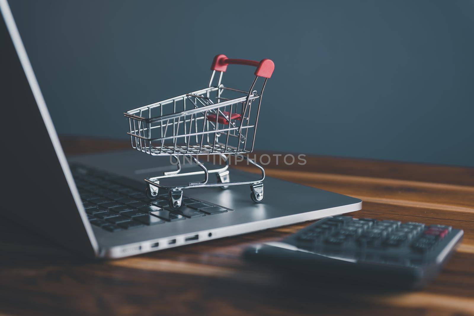 Mini Shopping Cart on Computer Laptop for Market E-Commerce Advertisement Concepts. Market E-commerce, Online Shopping Concept, Business Marketing Ecommerce Via Online Network.
