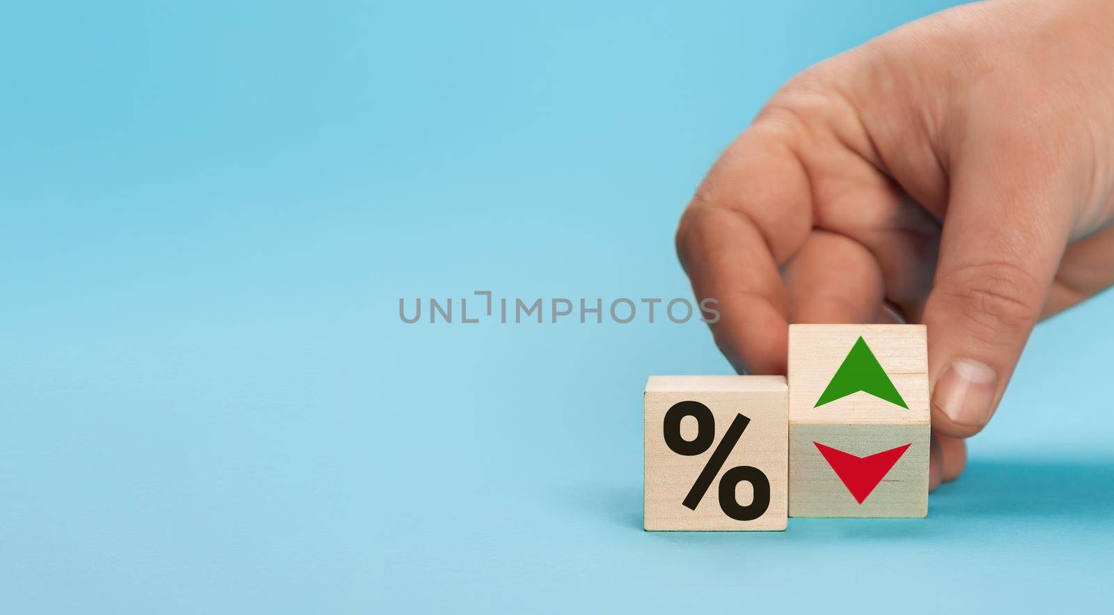 Cube block with percentage symbol icon. Interest rate financial and mortgage rates concept. Wood cube change arrow down to up. Interest rate, stocks, ranking. Business and finance concept