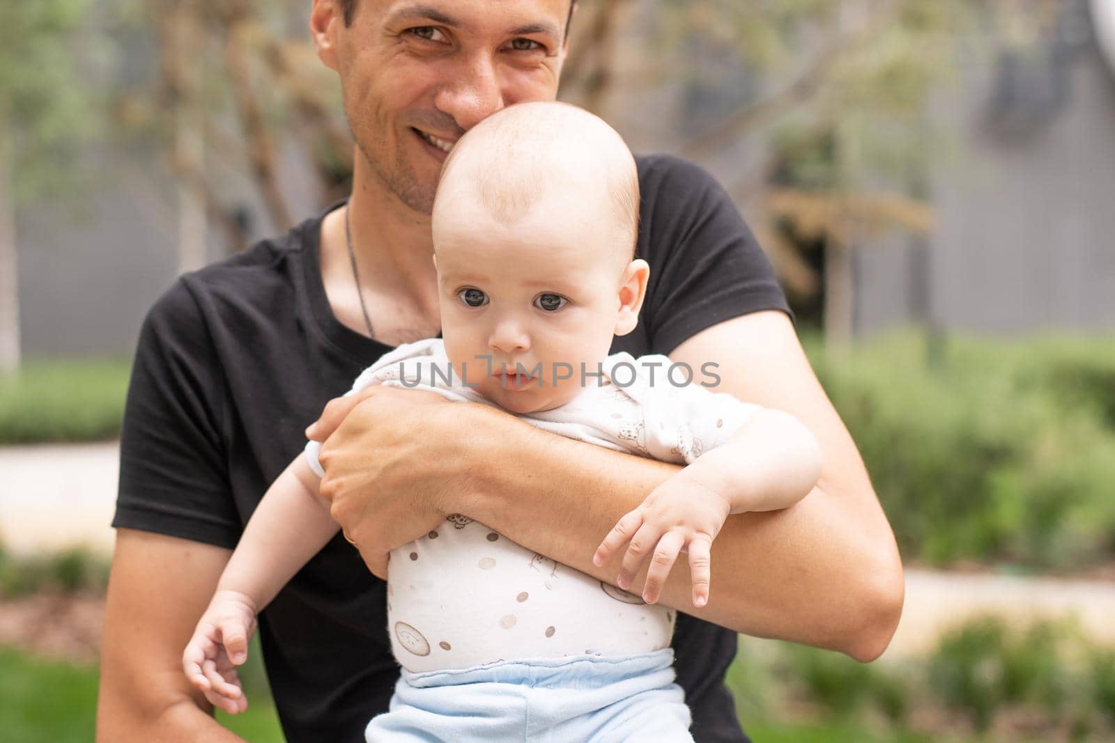 baby boy outdoor playing with father