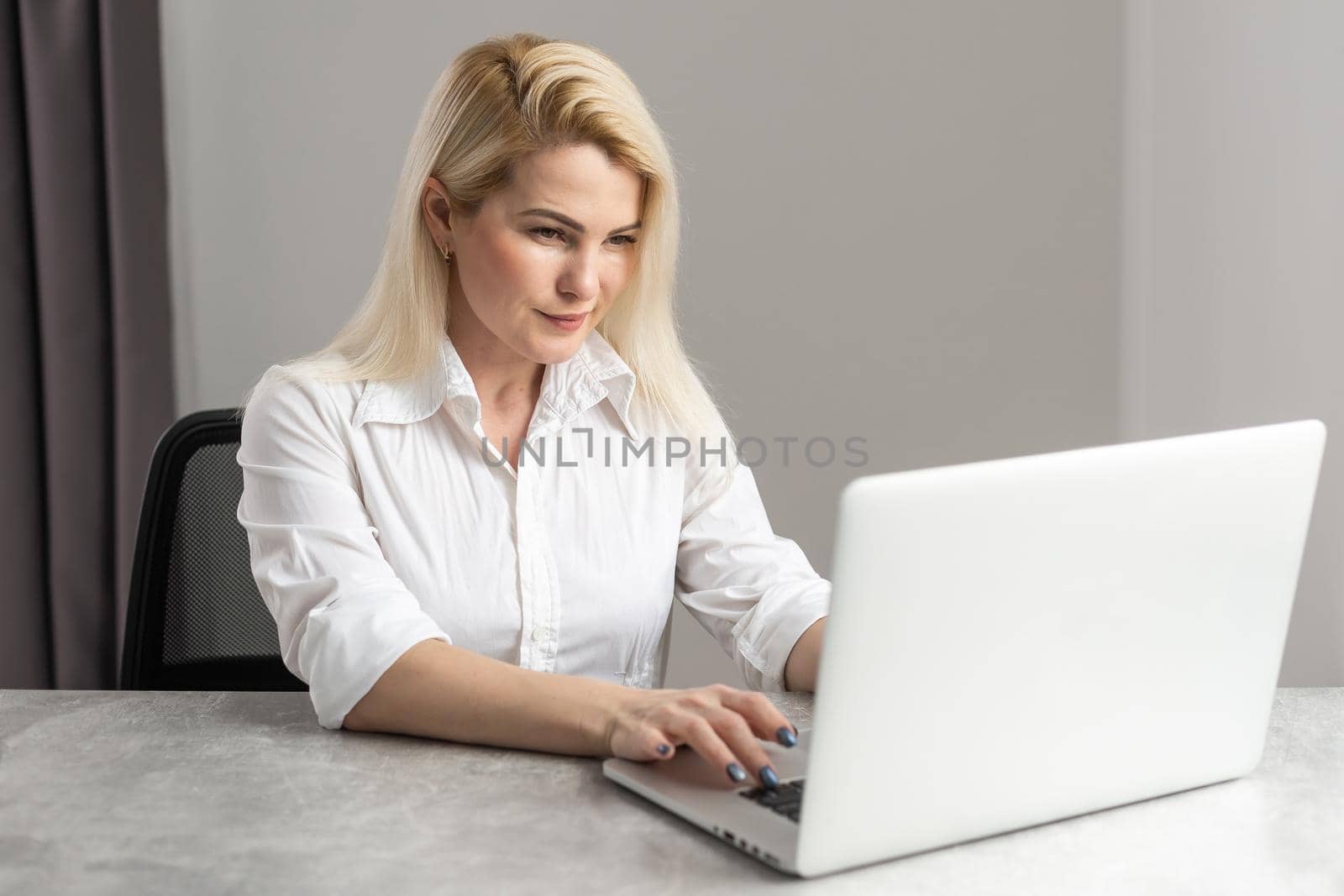 Shot of an attractive businesswoman working on laptop in her workstation