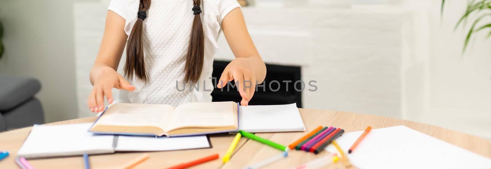 Cute pupil working at her desk