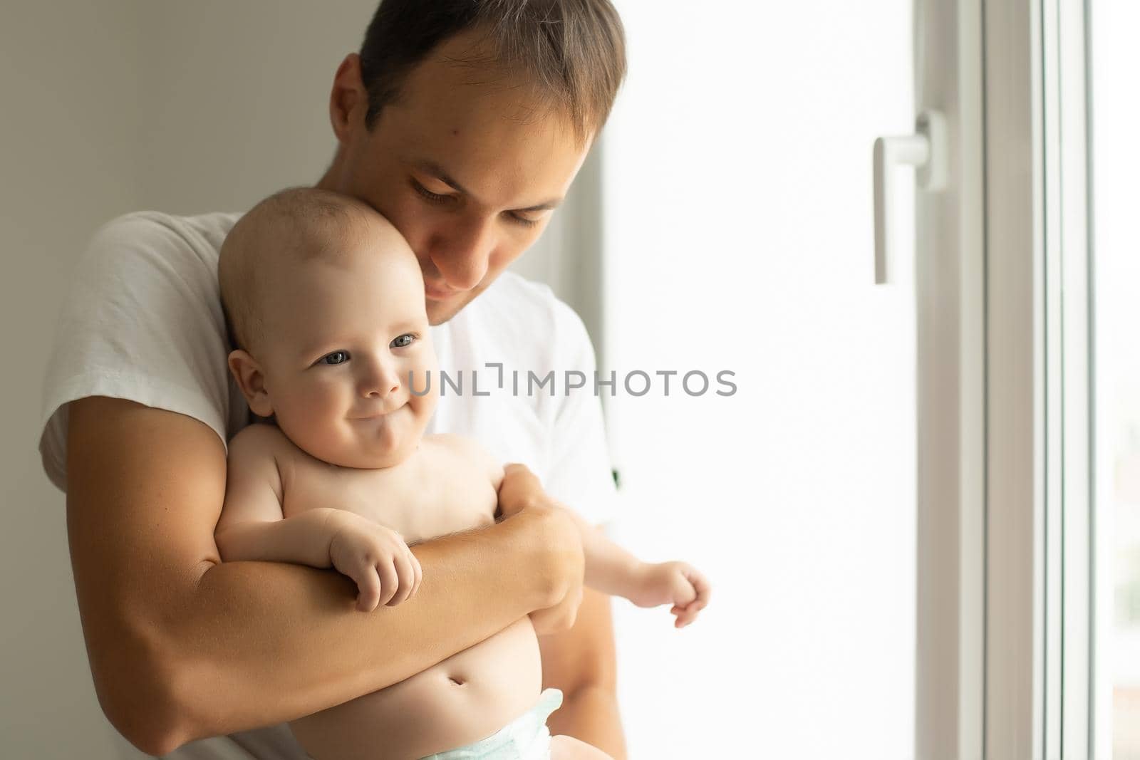 Happy middle age man holding his little baby.