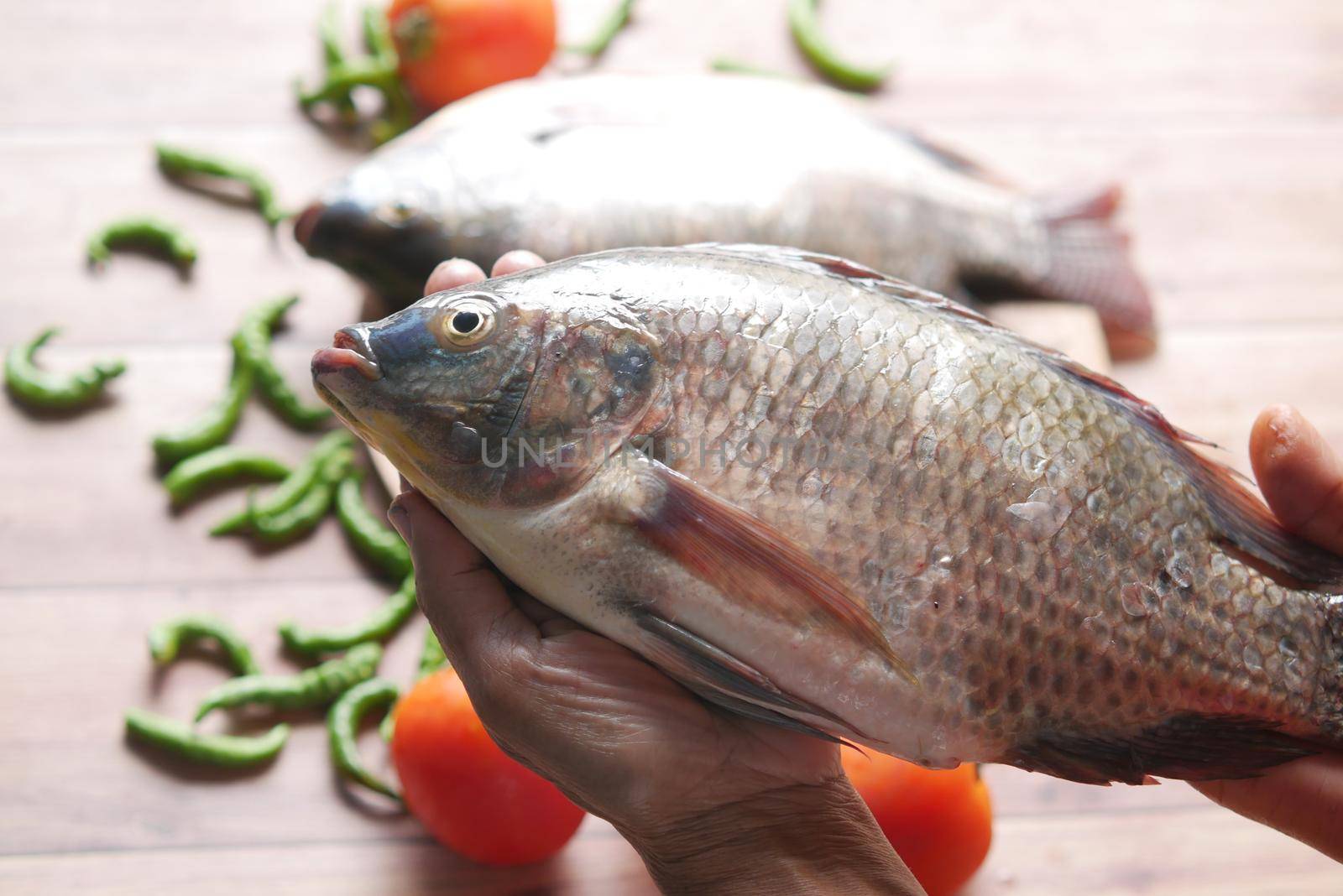 top view of raw fresh fish on hand .