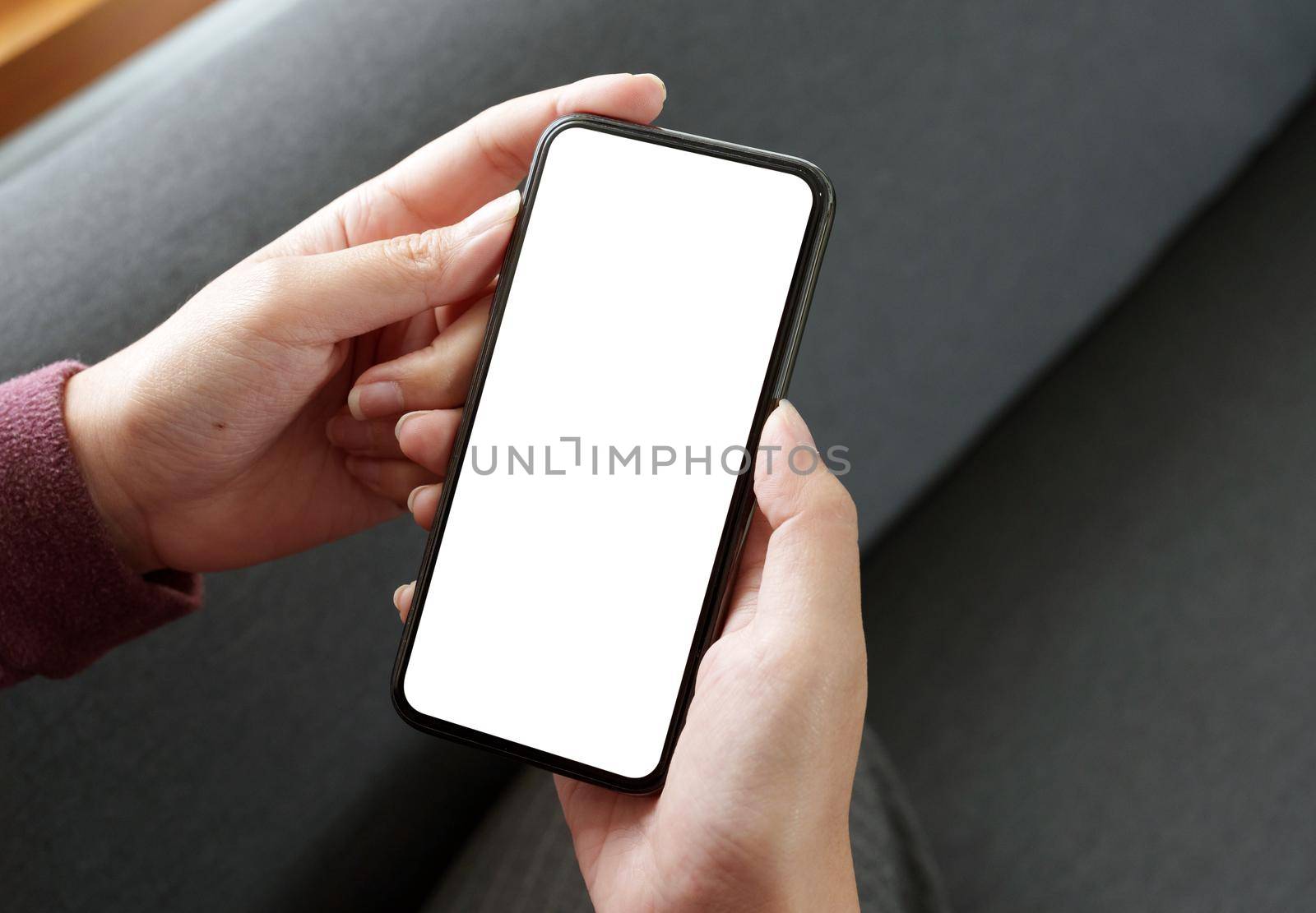 Top view Woman sitting and holding blank screen mock up mobile phone.