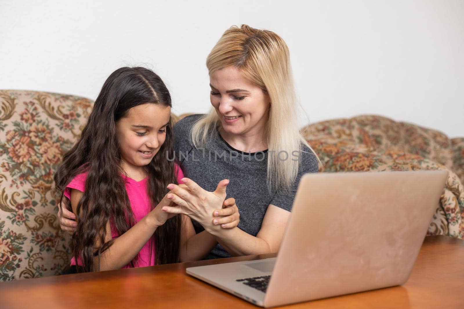 Happy family Mother and daughter watching videe entertainment with laptop computer technology the living room enjoy life at home concept.