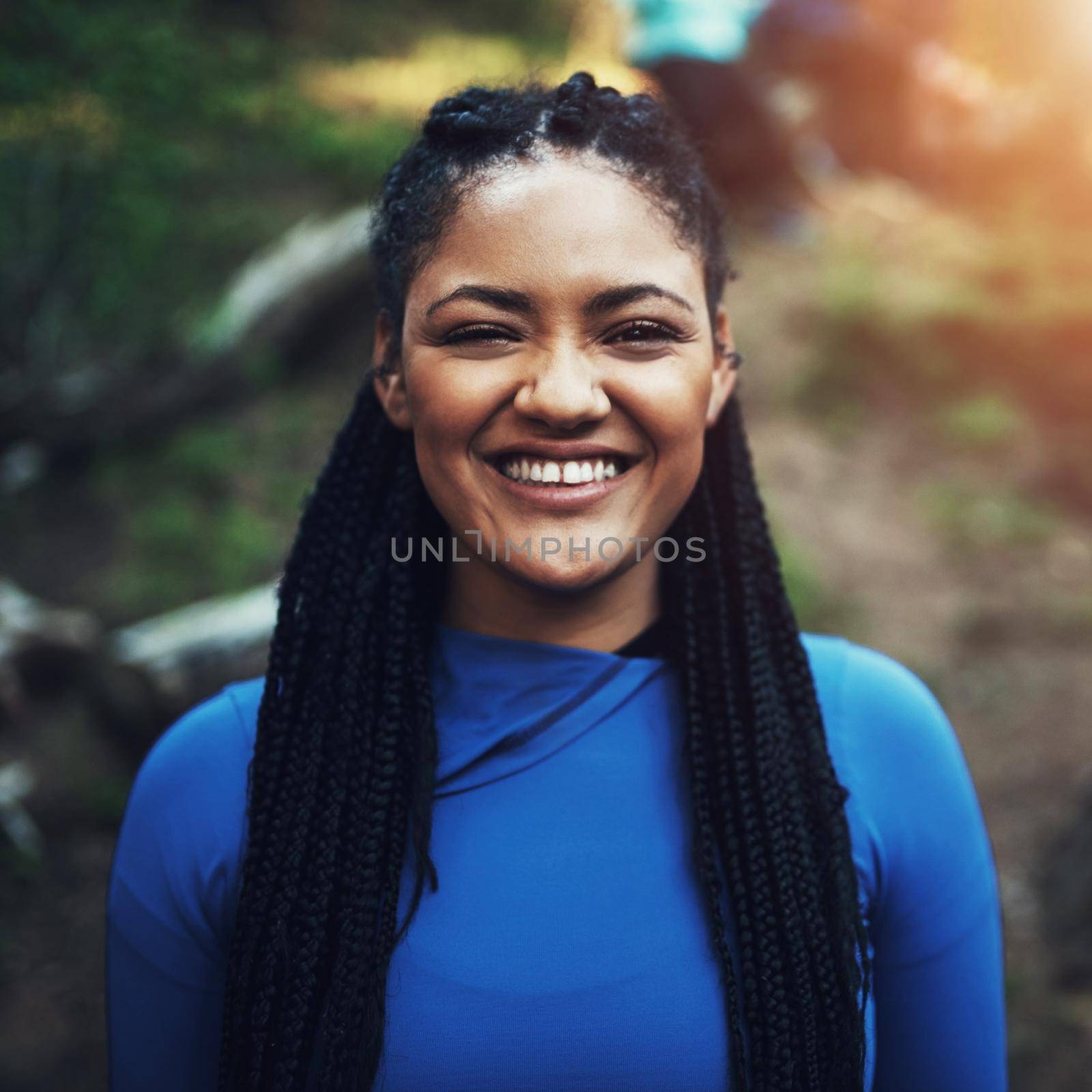 Portrait of a sporty young woman ready to workout in the forest.