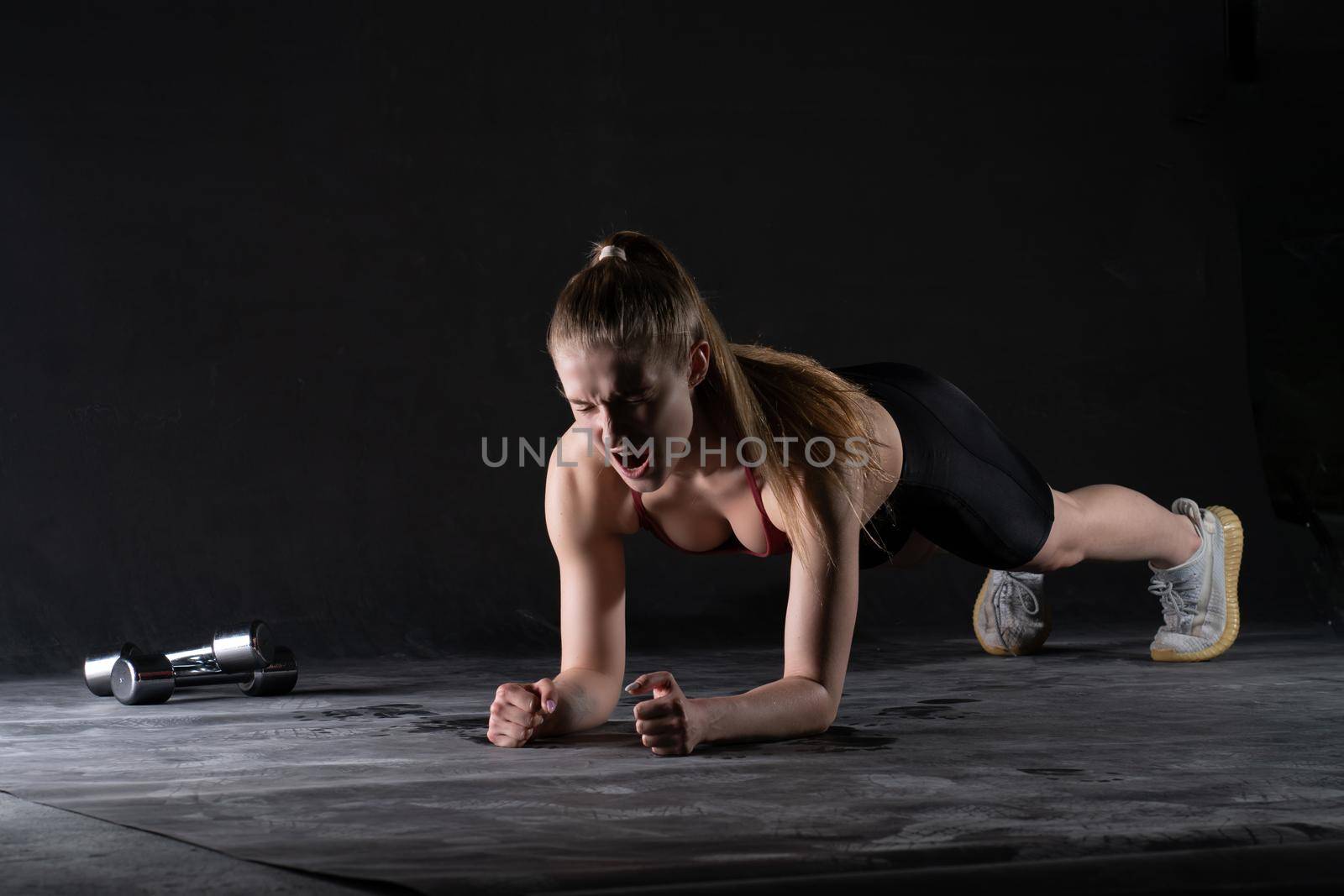 A with dumbbells the on in stands girl the plank floor push-ups looks like a kira knightley girl plank sports, for gym health from person for sport bodybuilding, strength sexy. Wellness ABS model