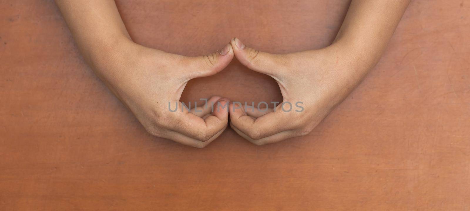 Heart shape created from little girl's hands. Lovely emotional, sentimental moment. Love, happiness and safety concept