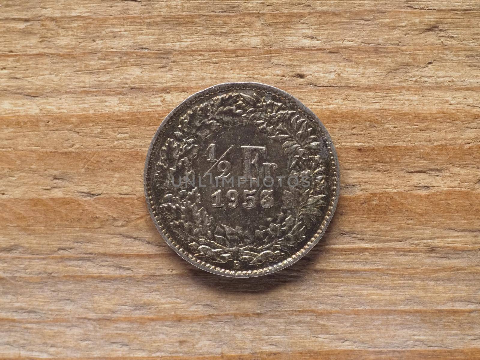 Half franc coin currency of Switzerland over wooden background