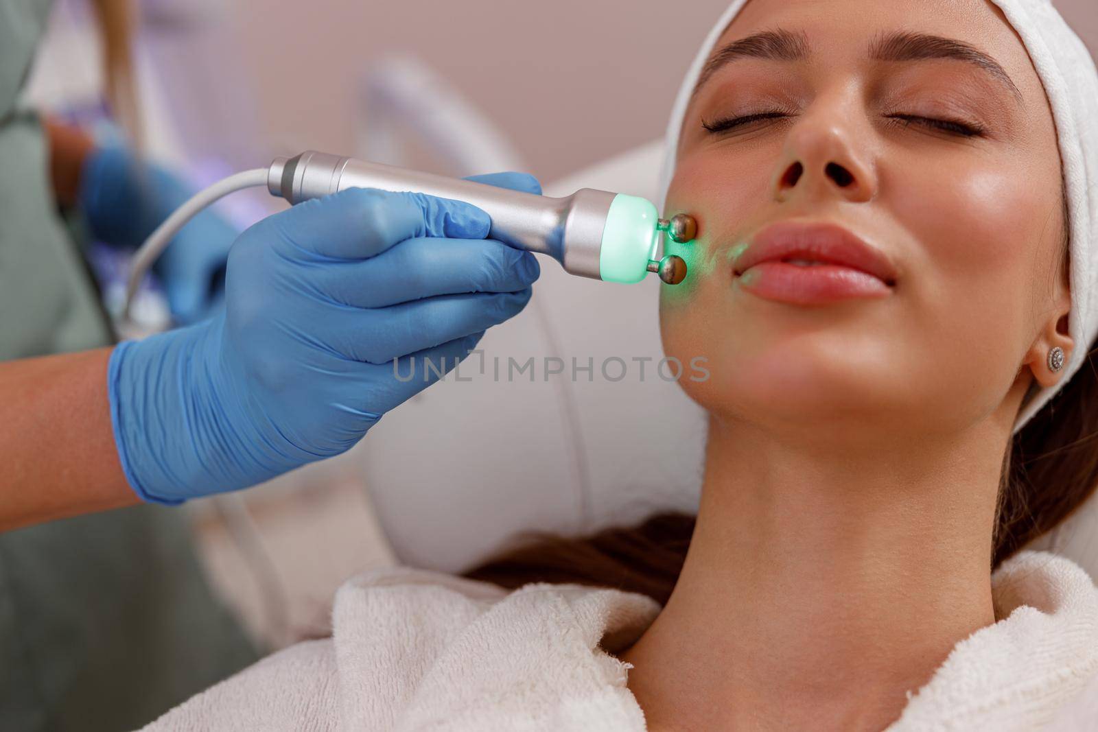 Closeup of young woman getting aesthetic skin treatment in beauty spa salon by Yaroslav_astakhov