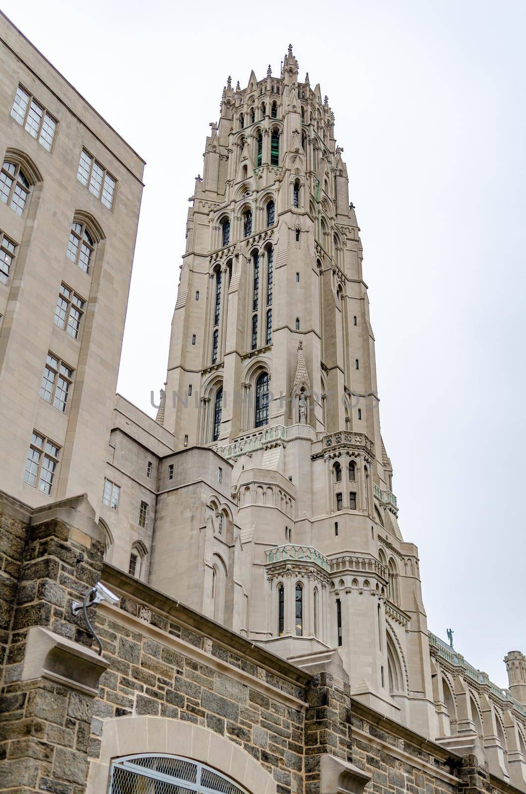 Riverside Church Tower view from low angle, Harlem, New York City, during winter day with overcast, vertical