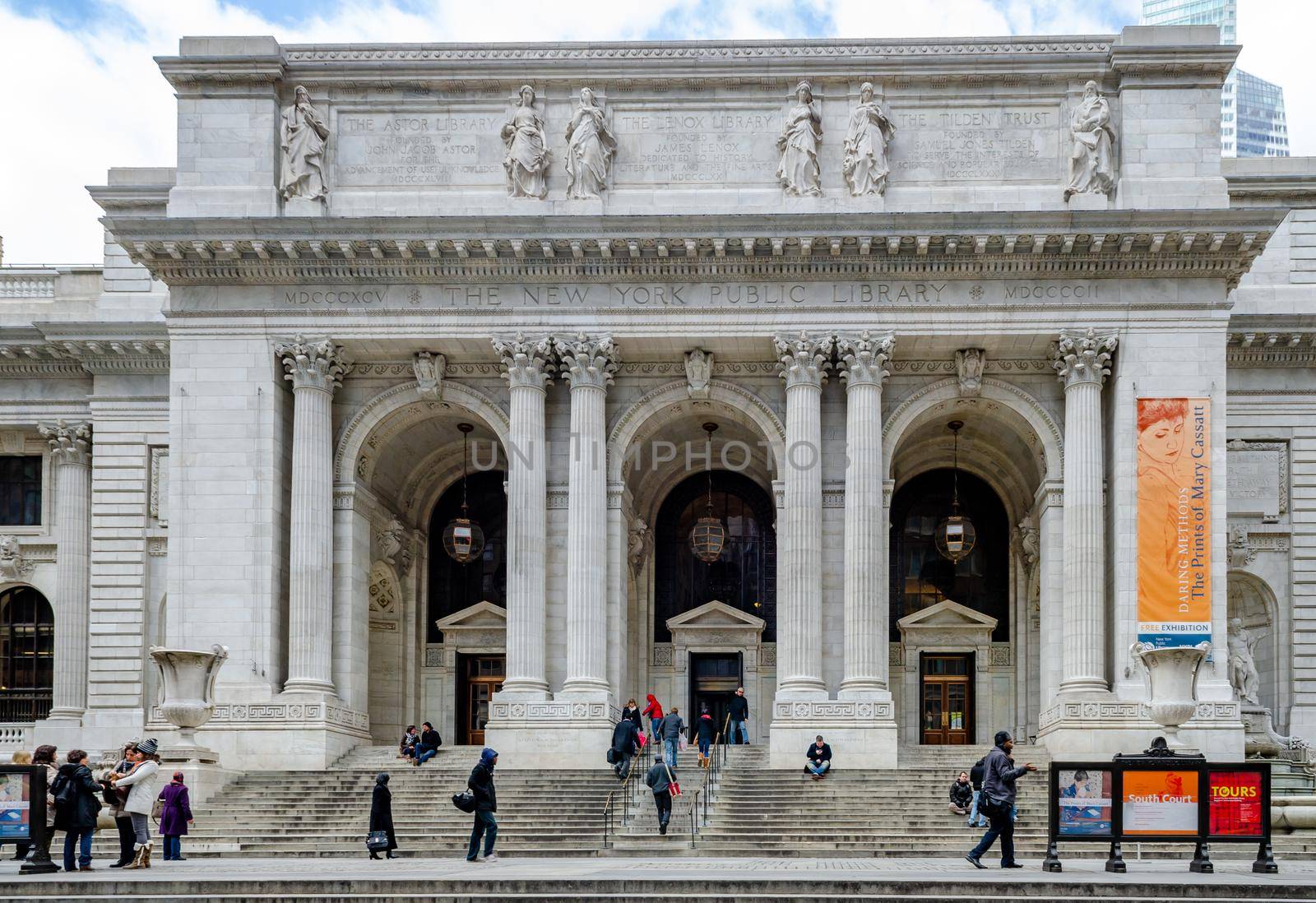 New York Public Library entrance with People walking in and out the building in forefront during daylight