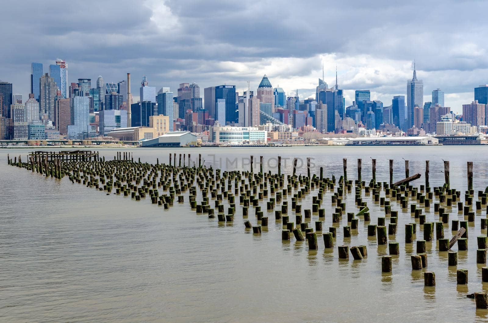 View of Manhattan, New York City with Hudson river and old landing stage in front by bildgigant
