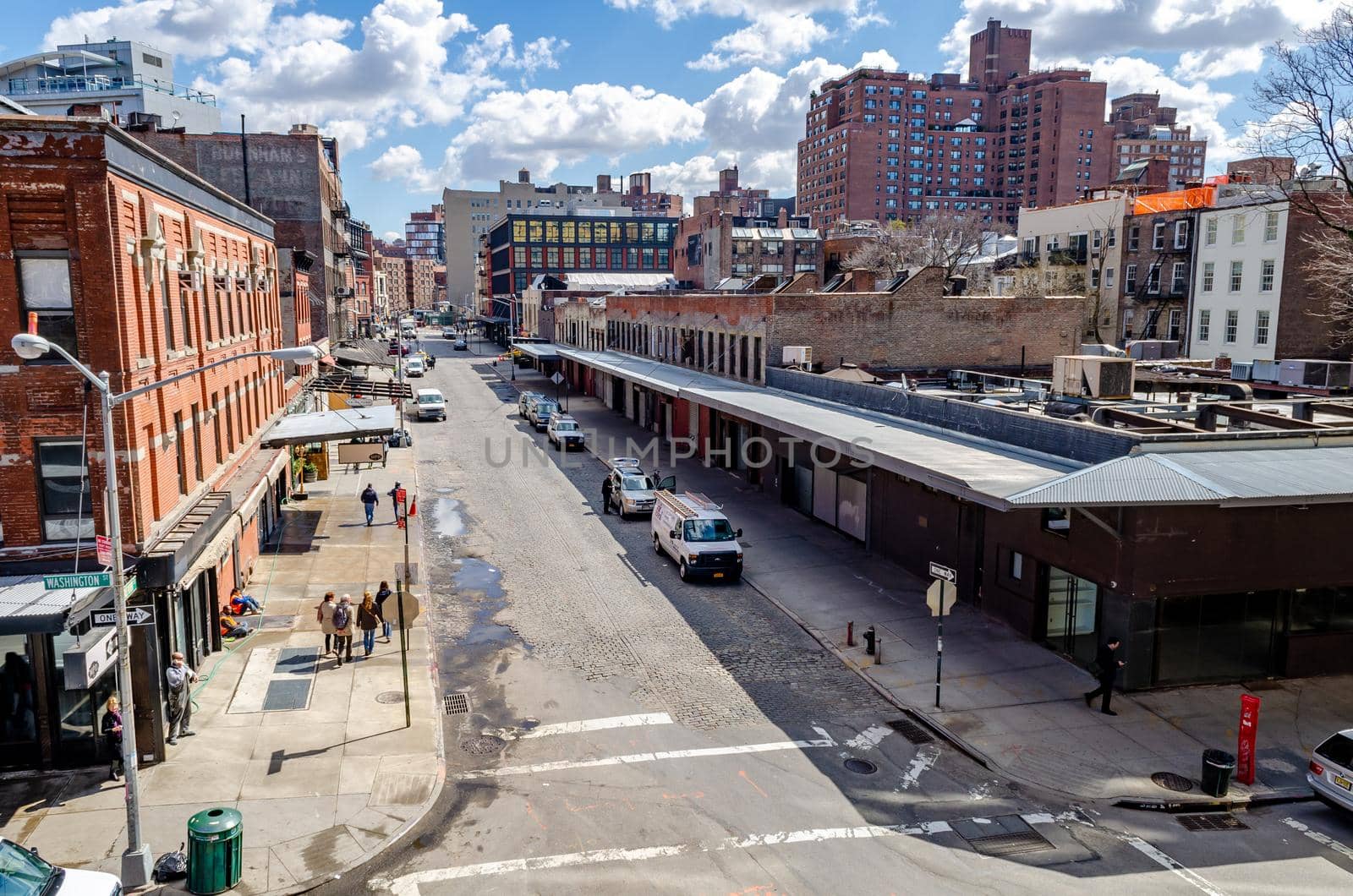 City Street in Chelsea, aerial view, New York City, view from the High Line Rooftop Park during sunny winter day, commercial buildings in the front and residential building in the background horizontal