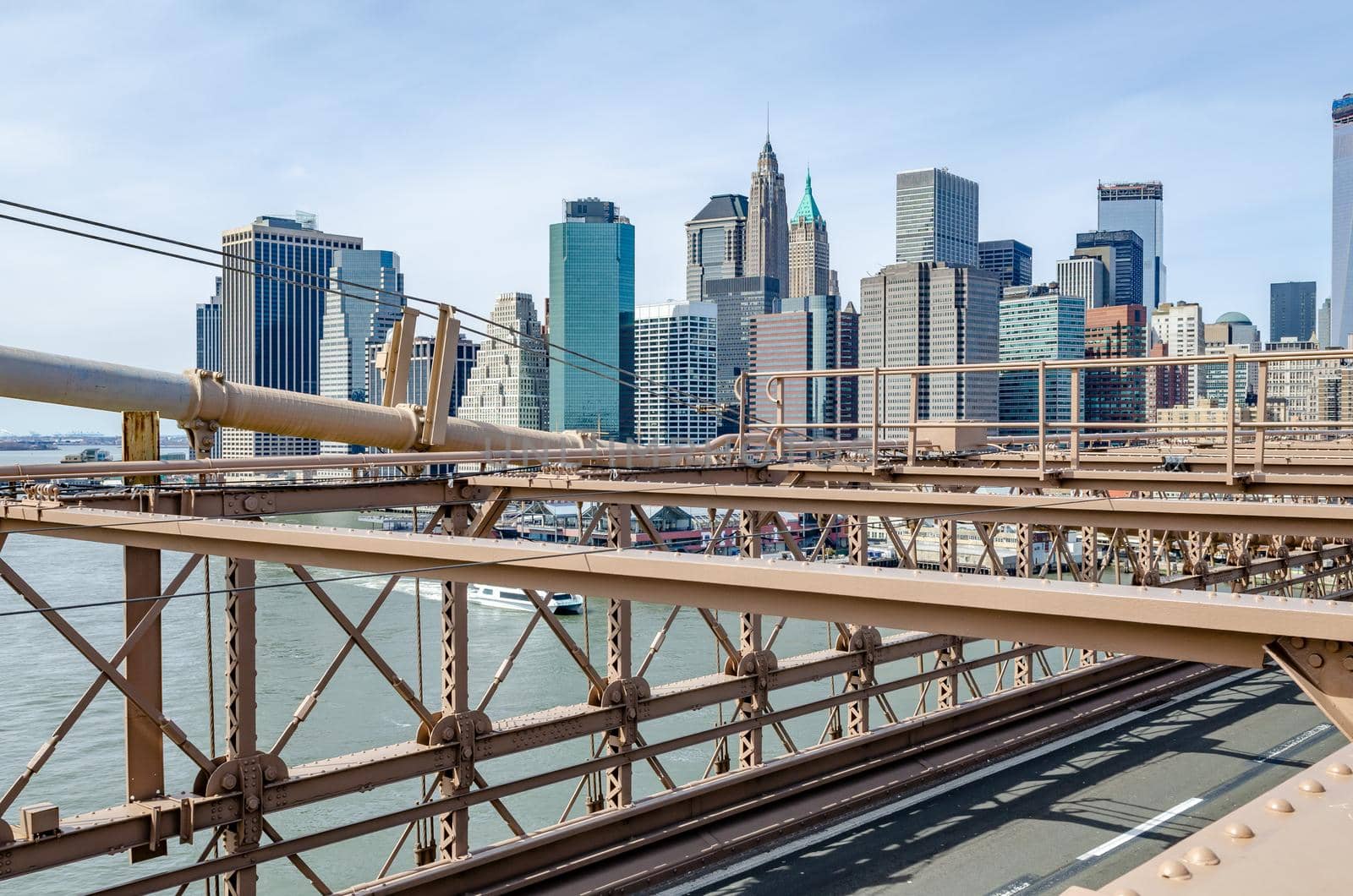 Skyline of Manhattan, New York City with Brooklyn Bridge in the forefront by bildgigant