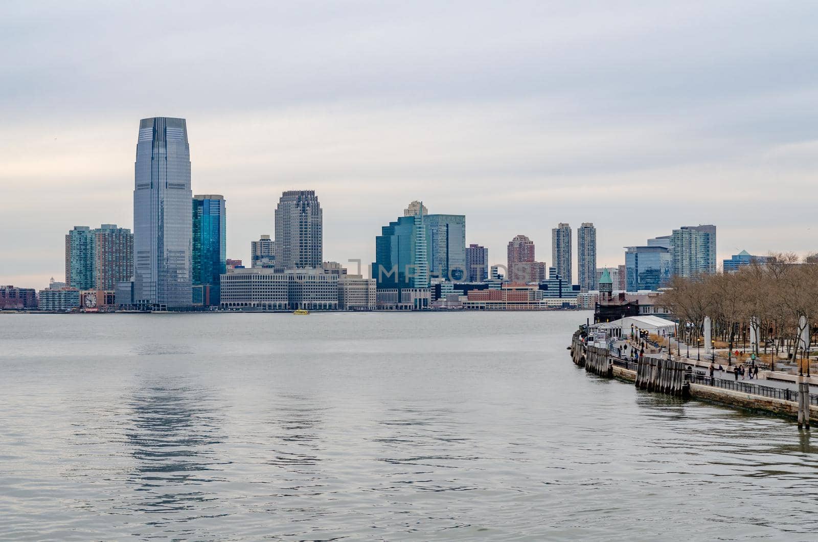 Jersey City, New Jersey with Hudson river and Manhattan river bank in forefront by bildgigant