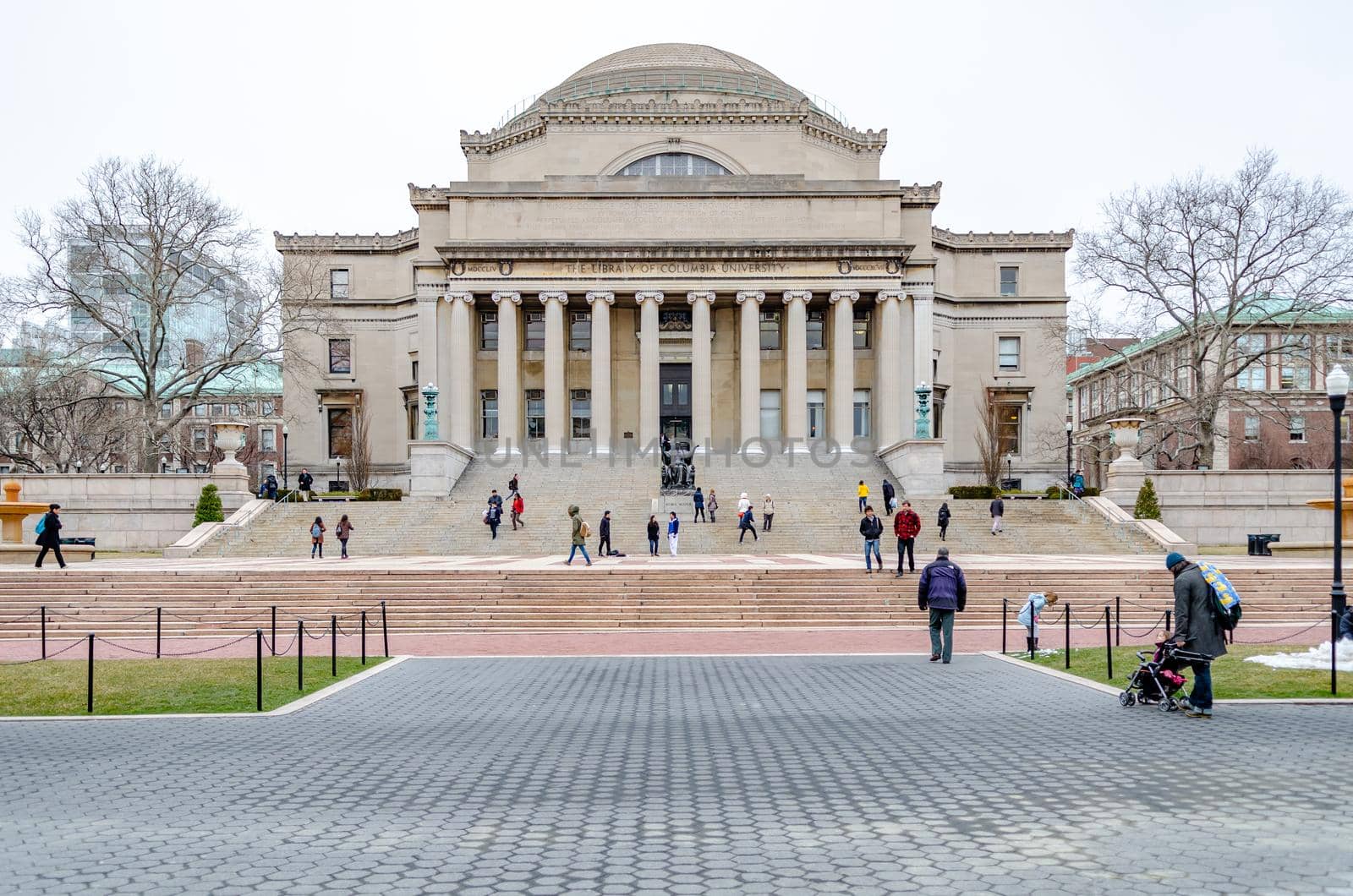 The Library of Columbia University with Students walking on staircase and park in front, New York City, during winter day with overcast, horizontal