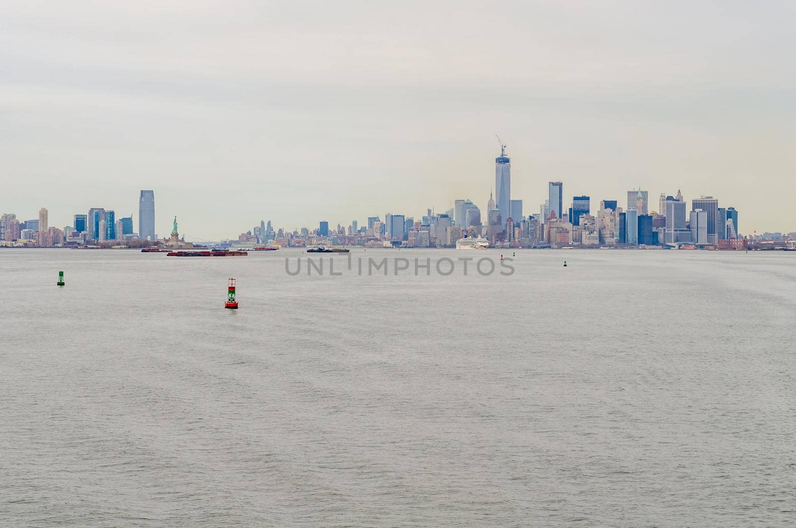 New York City Manhattan and Jersey City Skyline aerial view with Hudson river in the forefront, during winter day with overcast, horizontal