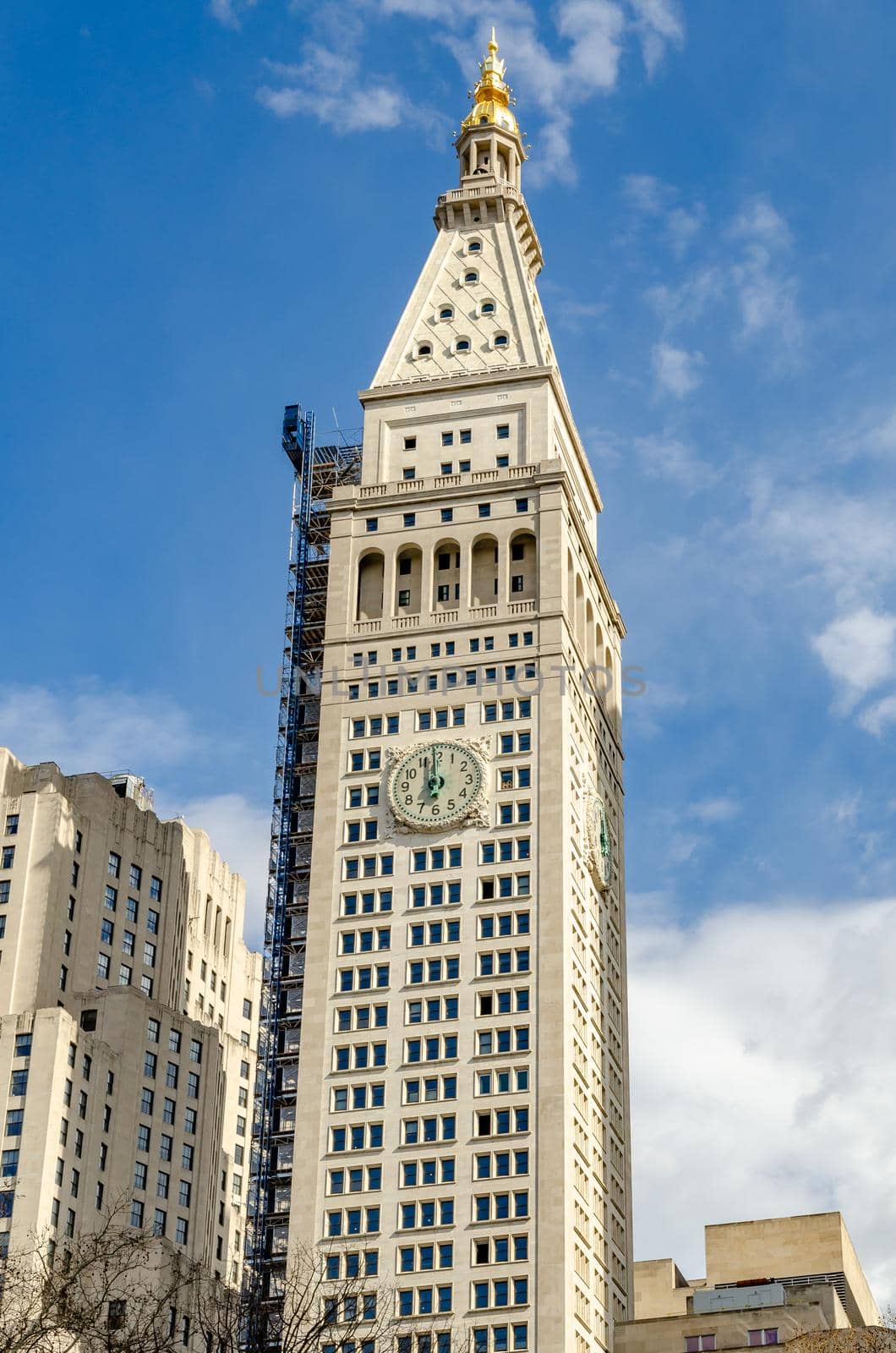 The New York EDITION Hotel Clock Tower, view from low angle, New York City during sunny winter day, Blue sky in the background, vertical