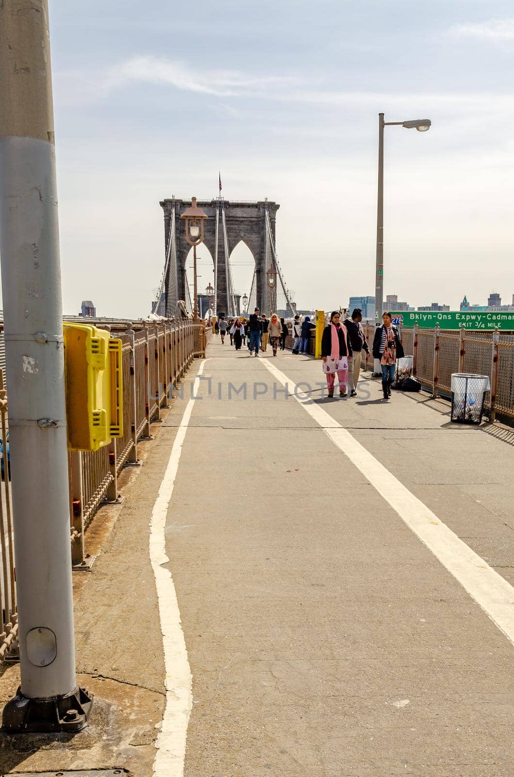 People walking on Brooklyn Bridge, NYC by bildgigant