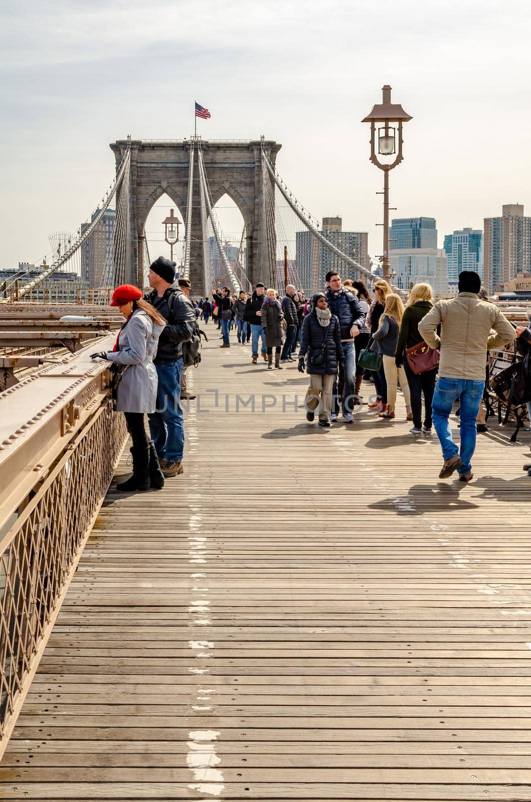 Brooklyn Bridge New York City with tourists walking on the Bridge by bildgigant